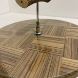 Vintage round wooden cheese board covered with glass plate with foldable handle