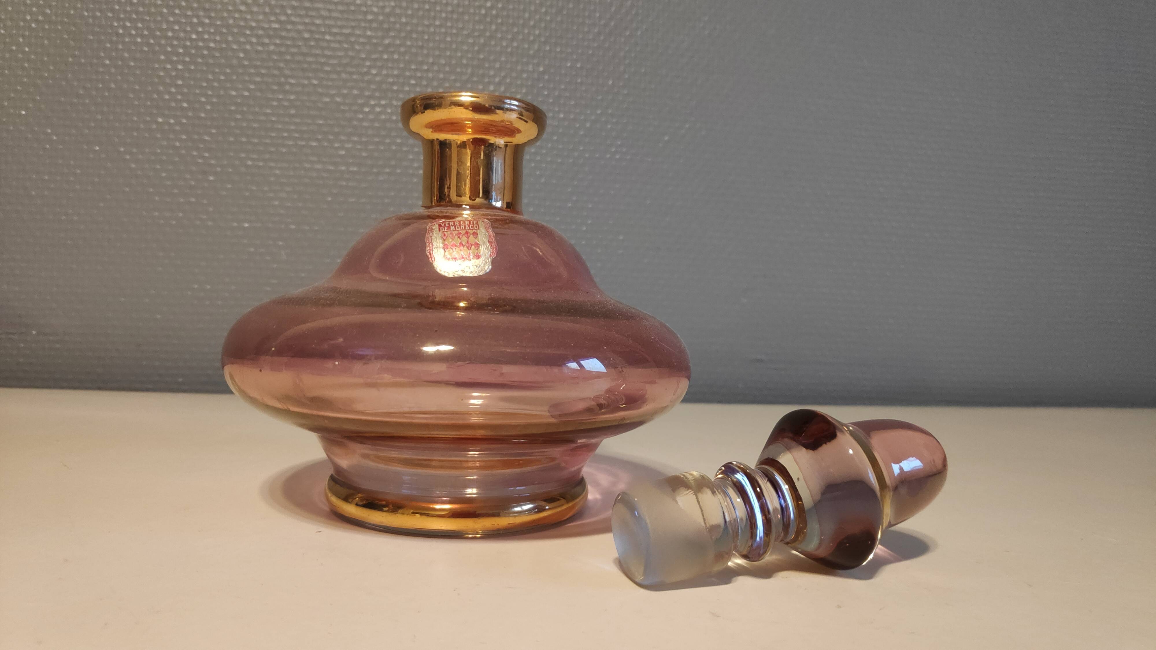 Pink and gold glass carafe stamped "Monaco glassware"