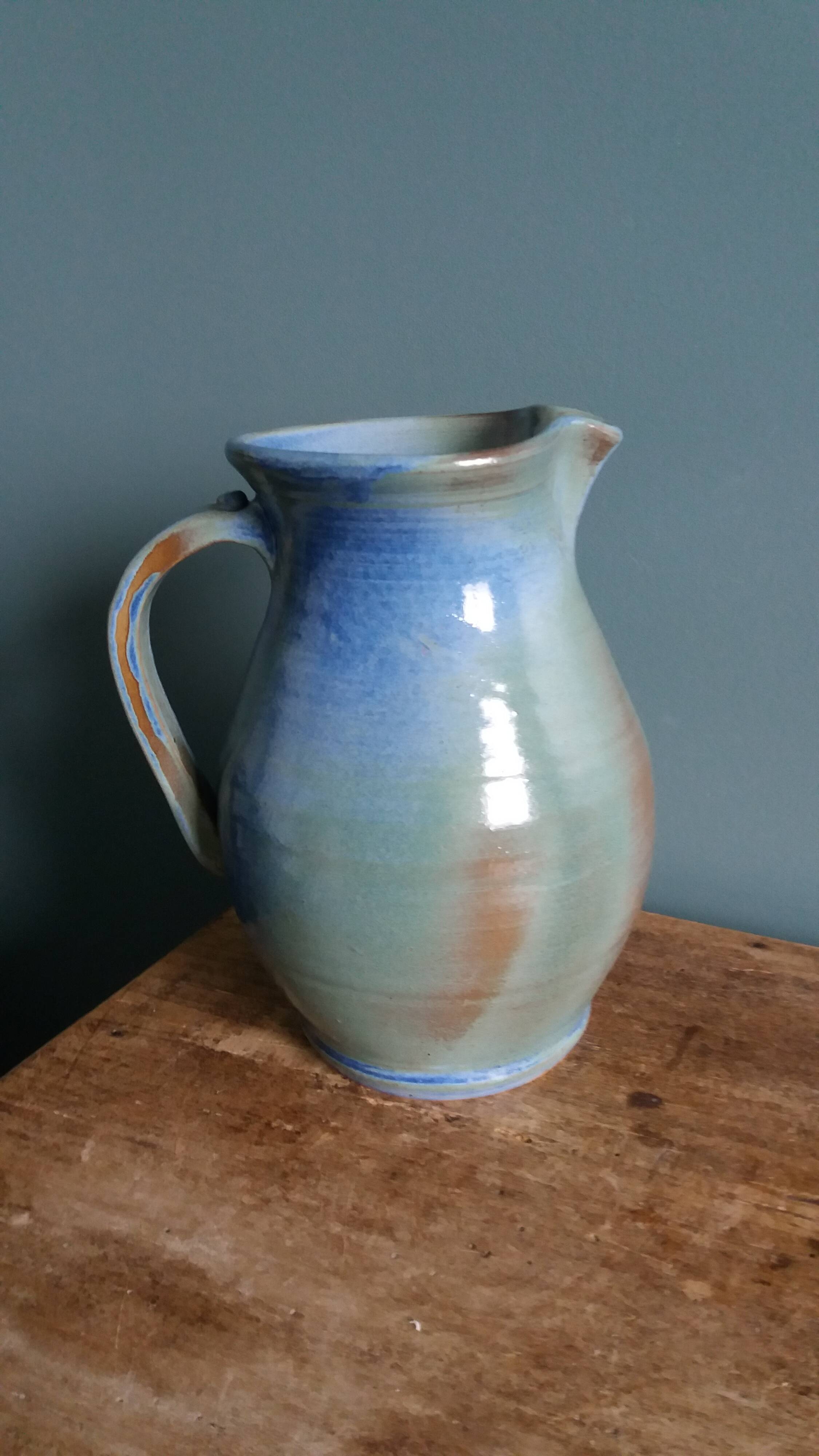 Enamel pitcher in pastel blue and green, signed
