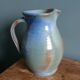 Enamel pitcher in pastel blue and green, signed
