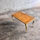 Mid-century wooden coffee table with golden metal legs and black-lined tabletop, 1950s