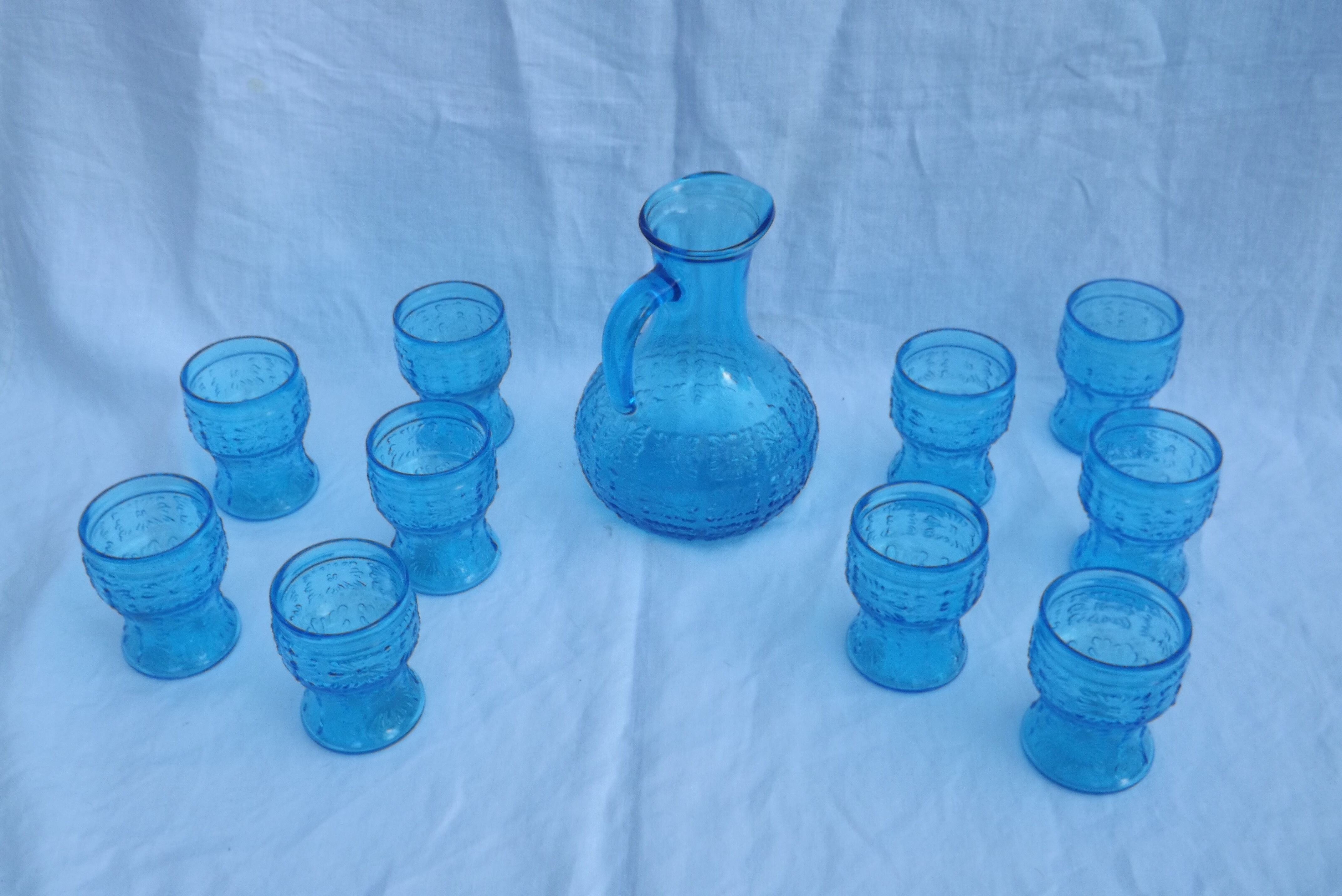 Set of jug and 10 blue glass goblets with floral motifs