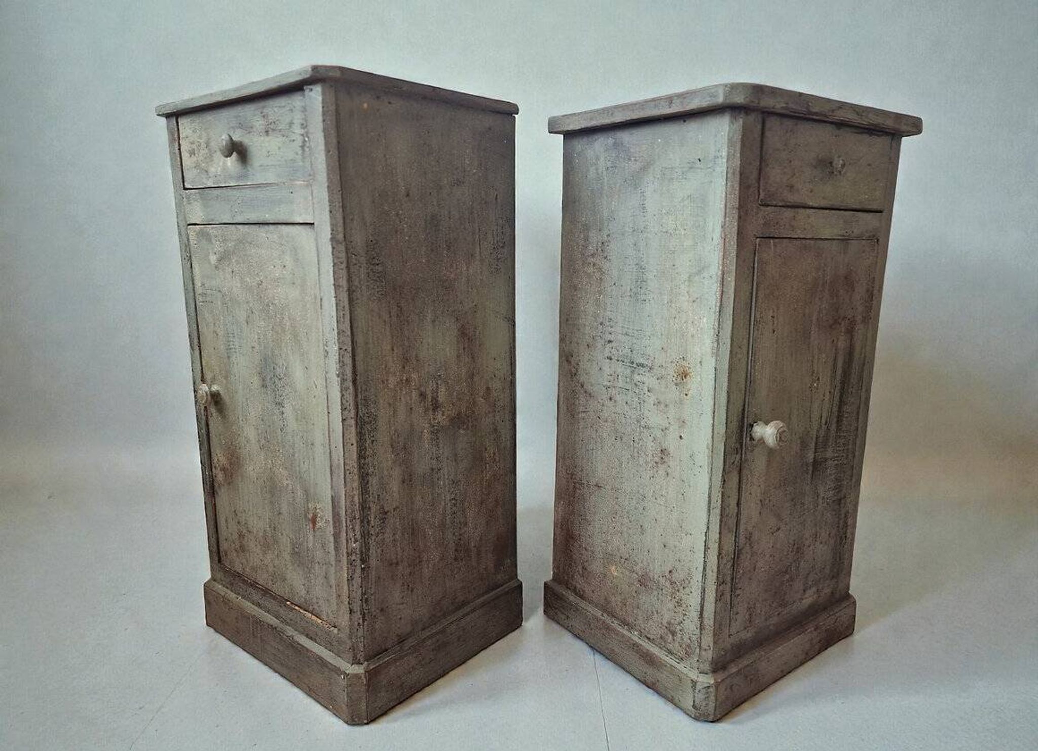 Pair of antique bedside tables with a green patina