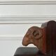Pair of carved wooden bookends in the shape of ram's heads.