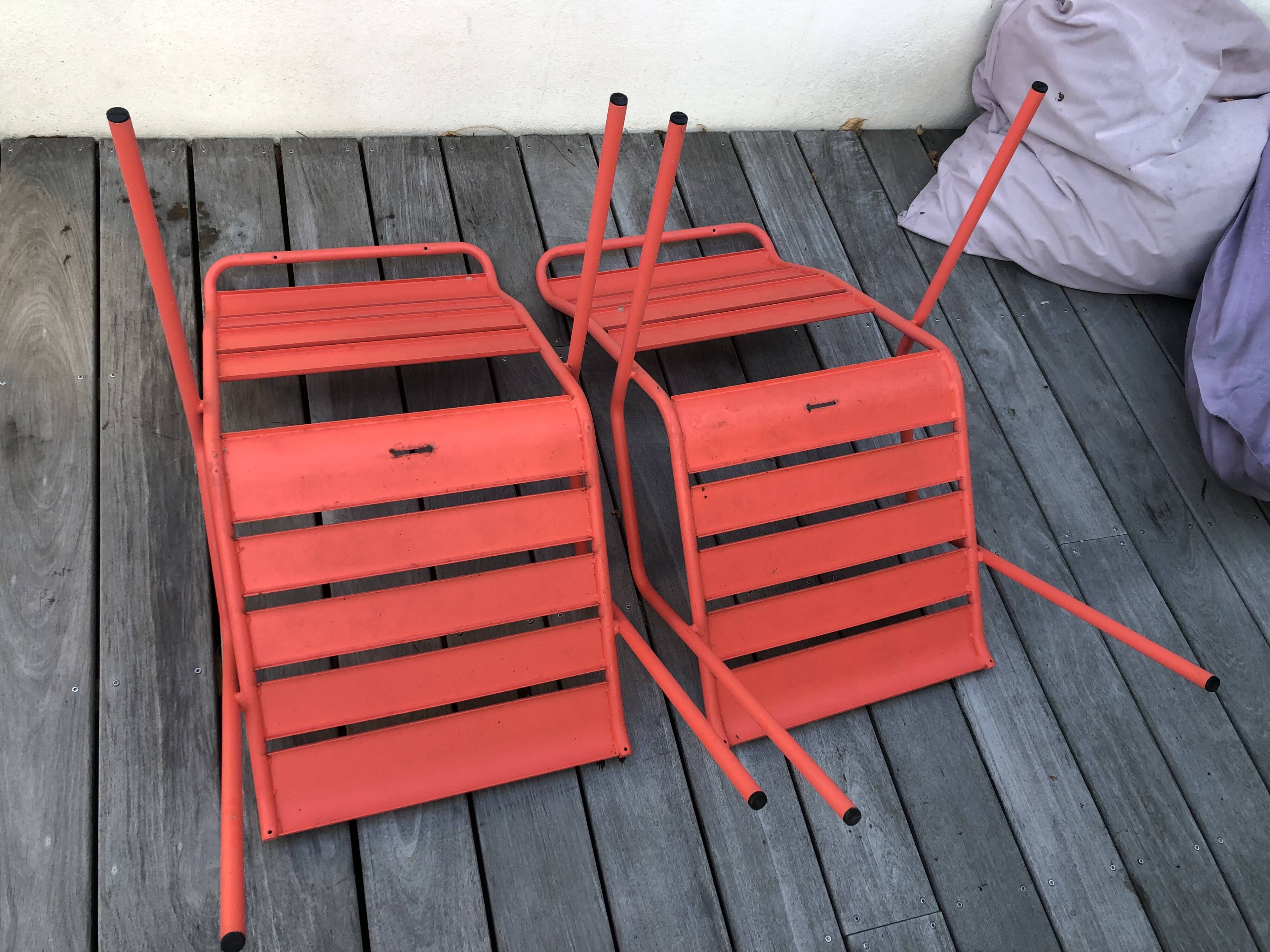 2 low chairs Fermob model Monceau in capucine colour.
