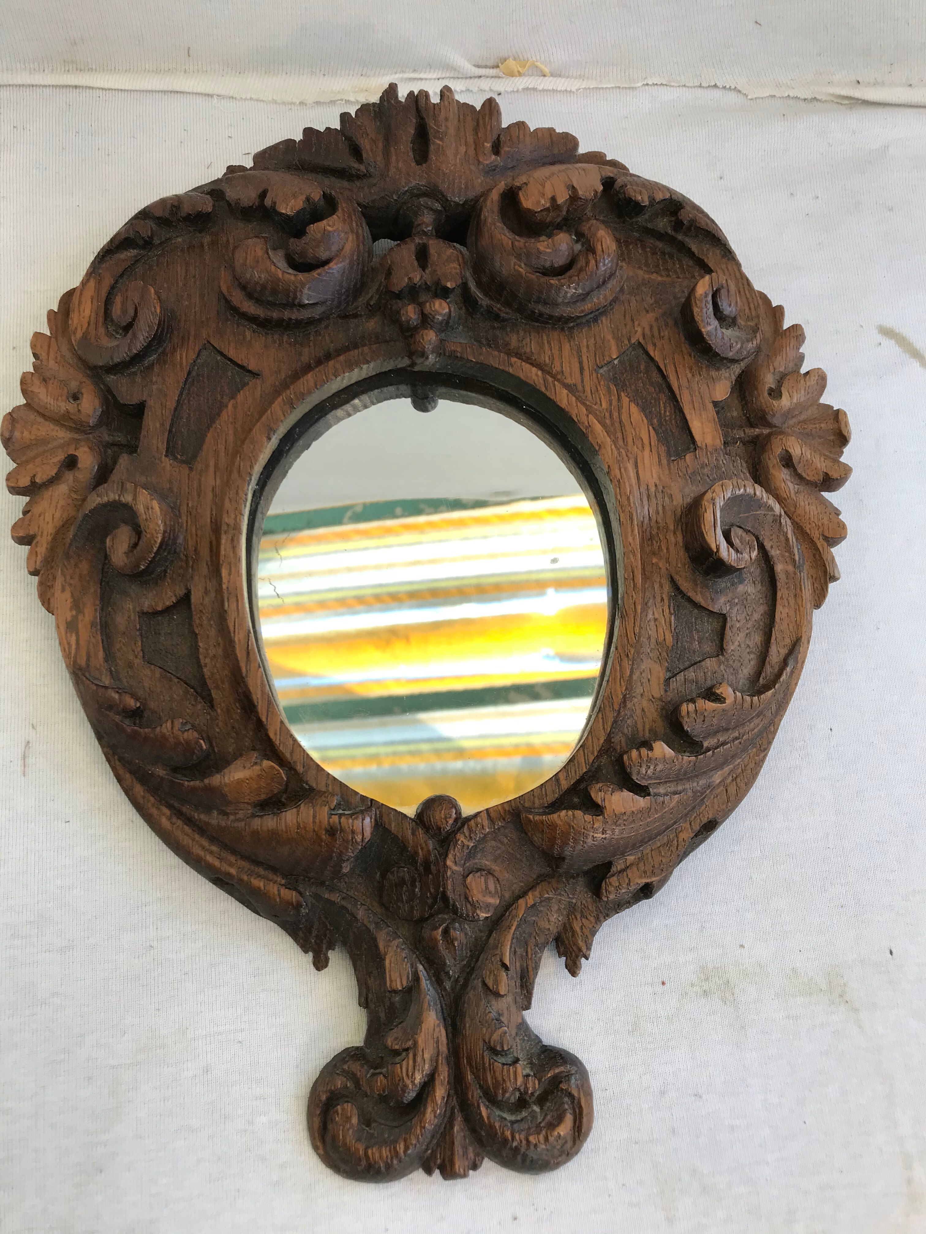 Ancient mirror in carved wood, vintage decoration