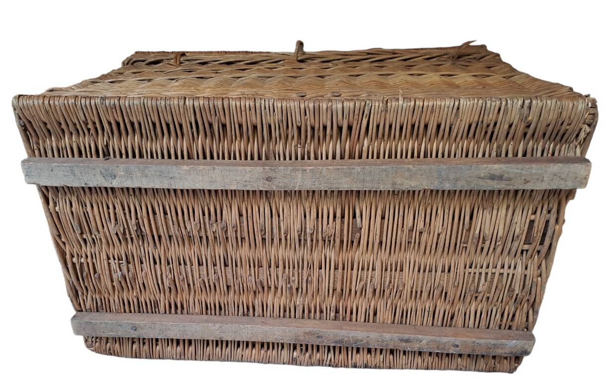 Wicker travel trunk XIX with metal clasps and handles.