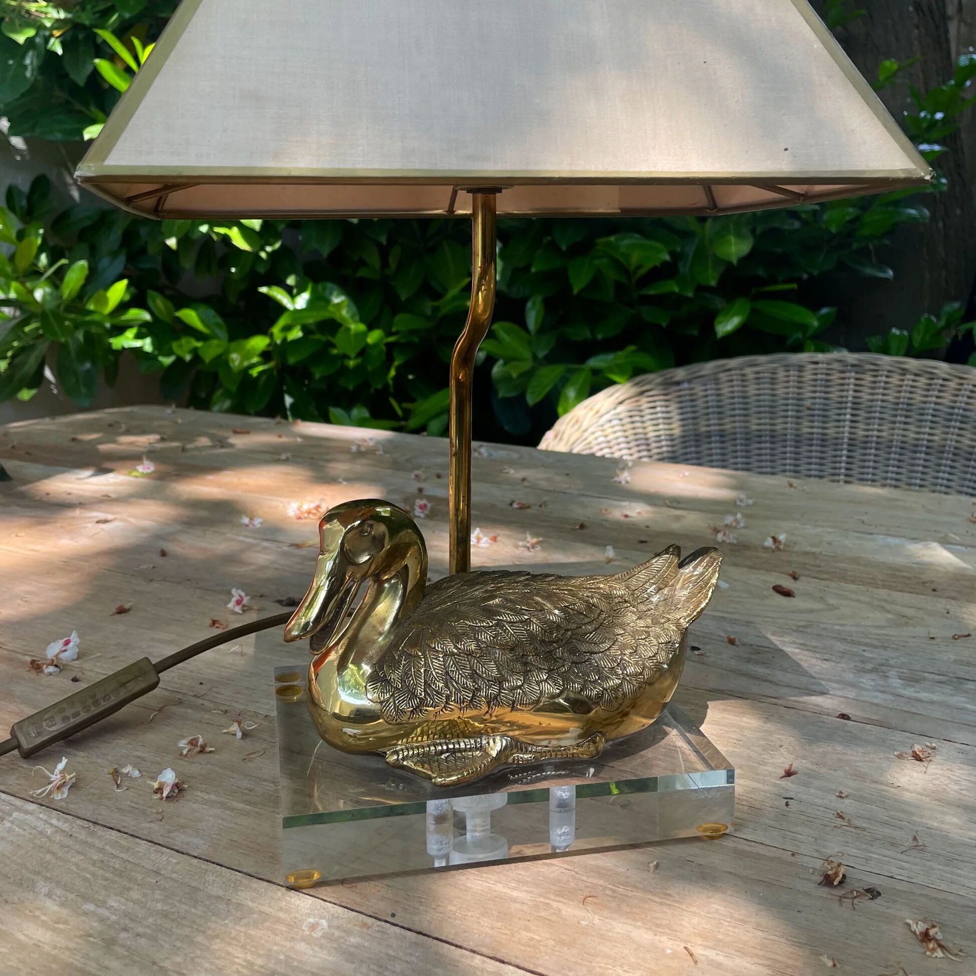 Vintage brass table lamp in the shape of a duck from the 1970s on an acrylic base.