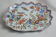 Desvres faience plate with polychrome decoration of a cornucopia.
