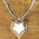 Vintage deer hunting trophy massacre on light varnished wooden shield