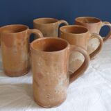 Suite of five sandstone mugs