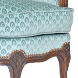 Pair of Louis XV style wingback armchairs with five legs.