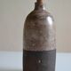 Ceramic bottle vase with a fish signature to be identified.