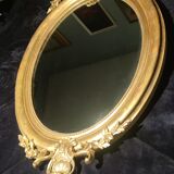 Ovoid mirror with double pediments gilded with leaf circa 1830, 105x66 cm