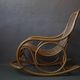 Vintage rocking chair in rattan from the 60s-70s, high openwork backrest.