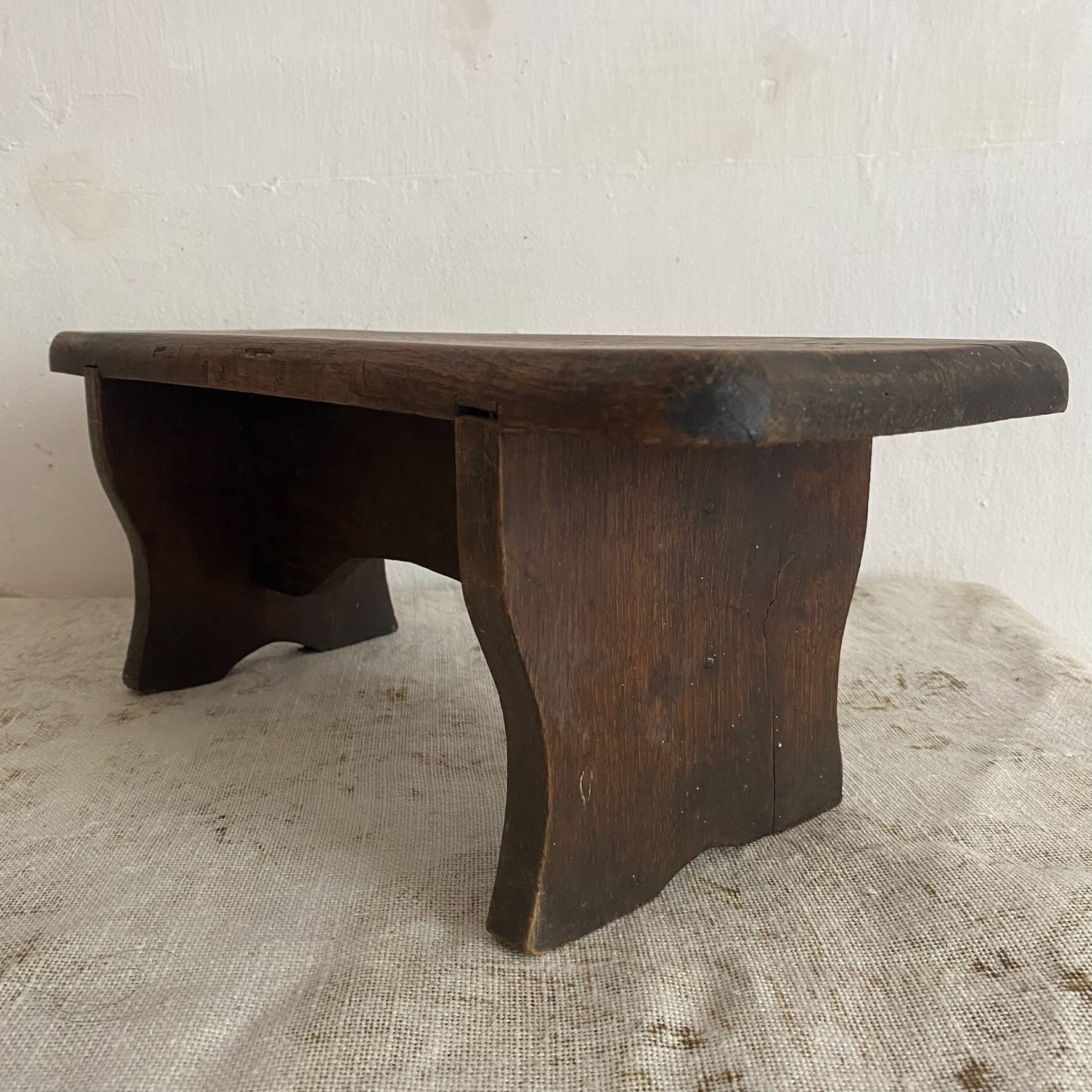 Old low stool made of solid wood
