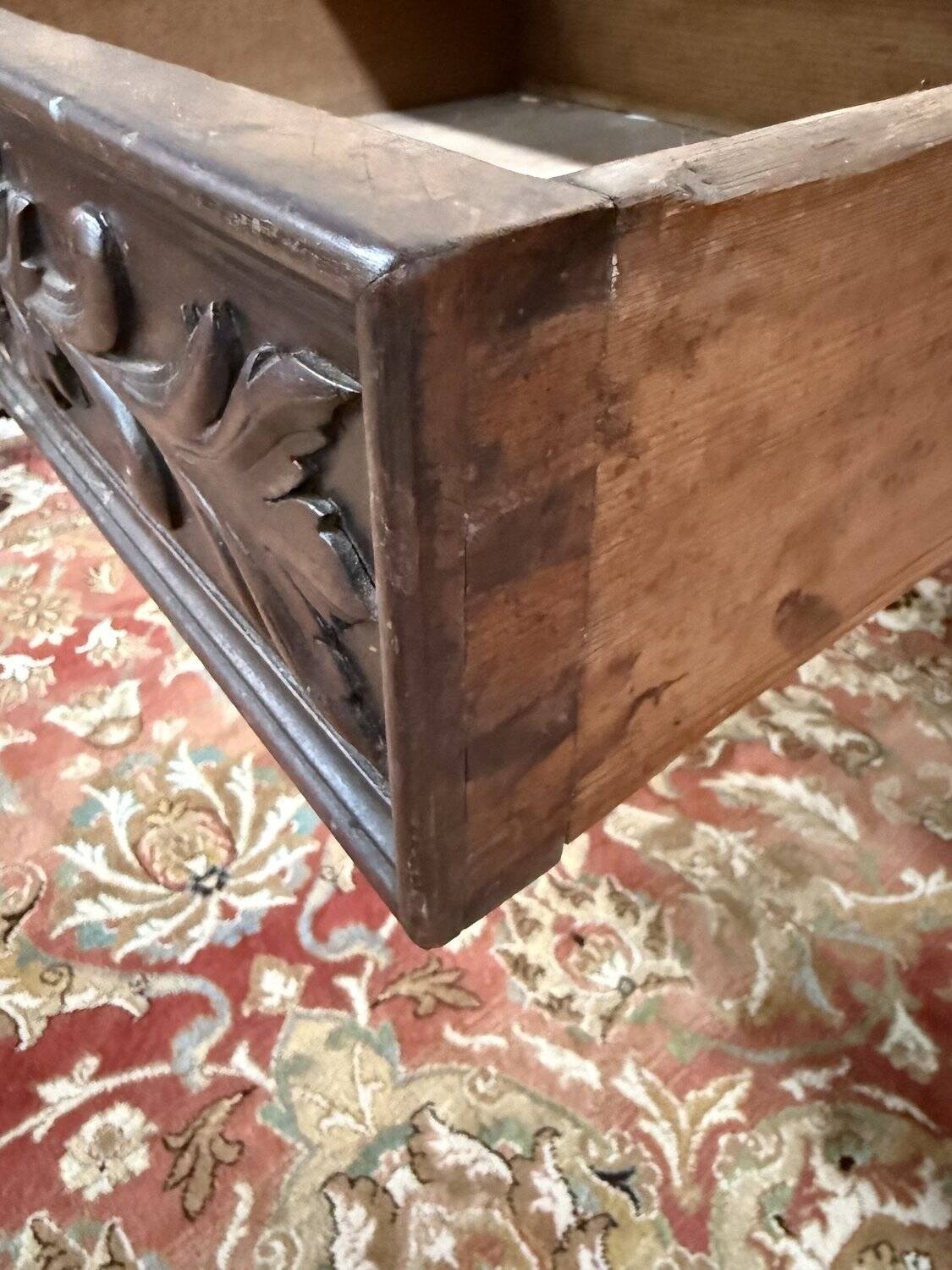 Middle table in a sculpted Louis XIII style living room.