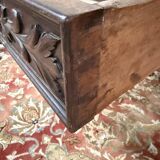 Middle table in a sculpted Louis XIII style living room.