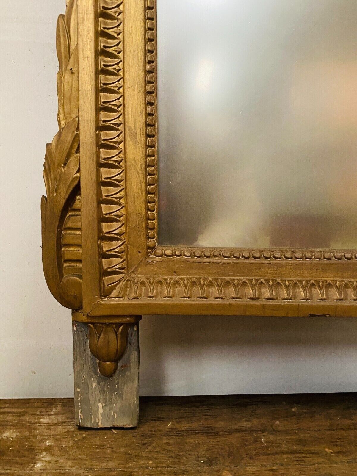Louis XVI style mirror in wood and gilded stucco XIX century,, 122x72 cm