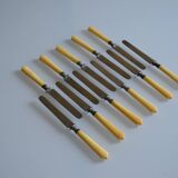 11 antique dessert knives from the 19th century with ivory-colored handles and a monogram