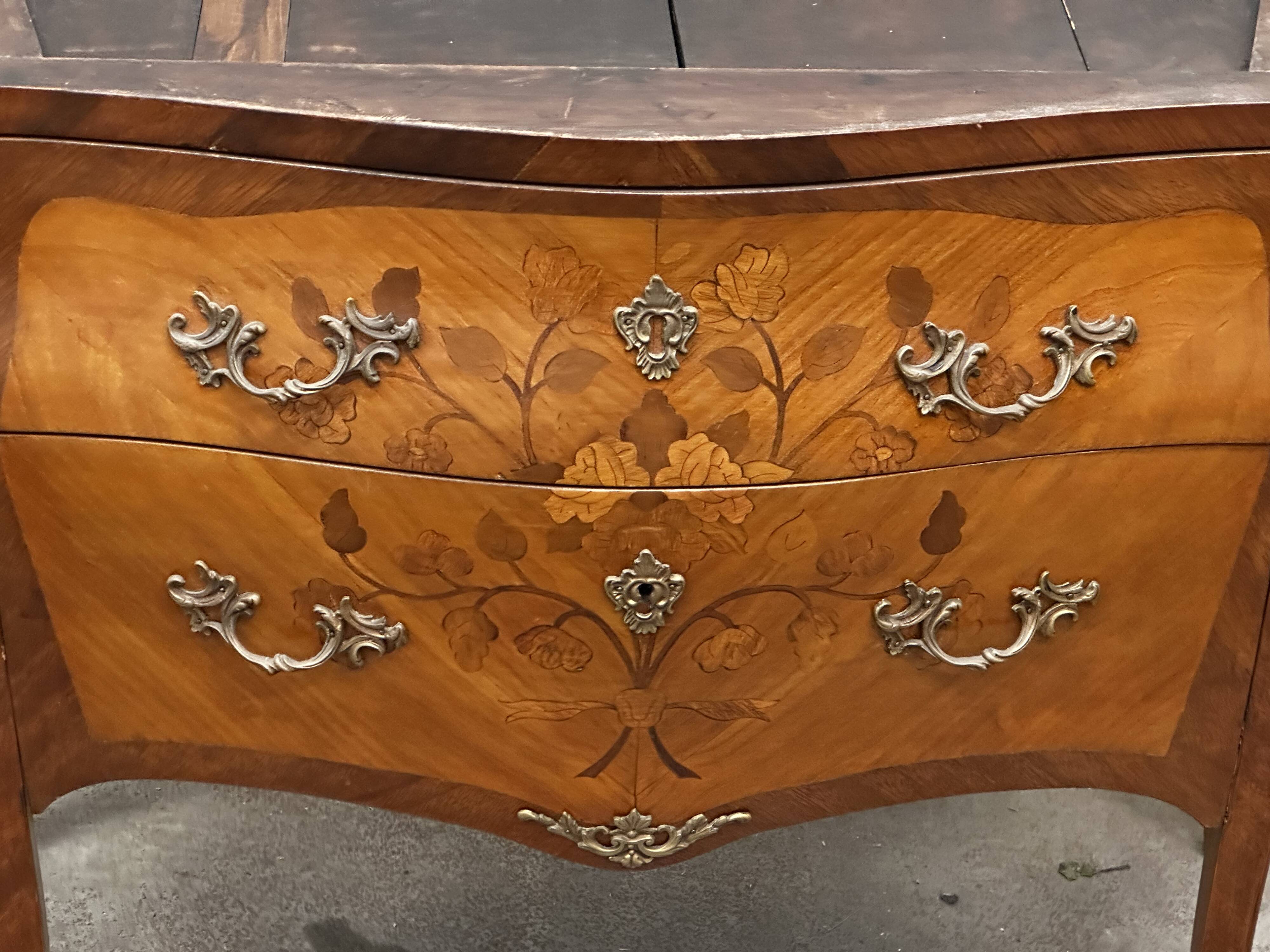 Curved and inlaid Louis XV style chest of drawers