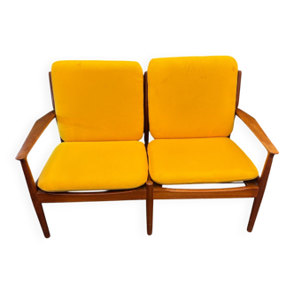 Vintage Scandinavian two-seater bench with mustard yellow cushions.
