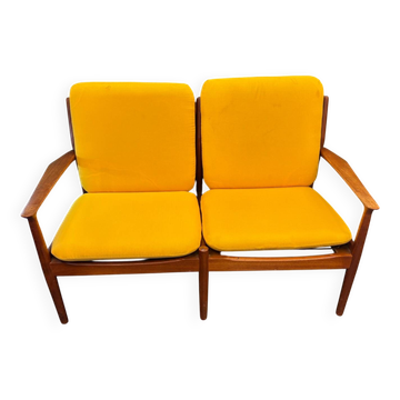 Vintage Scandinavian two-seater bench with mustard yellow cushions.