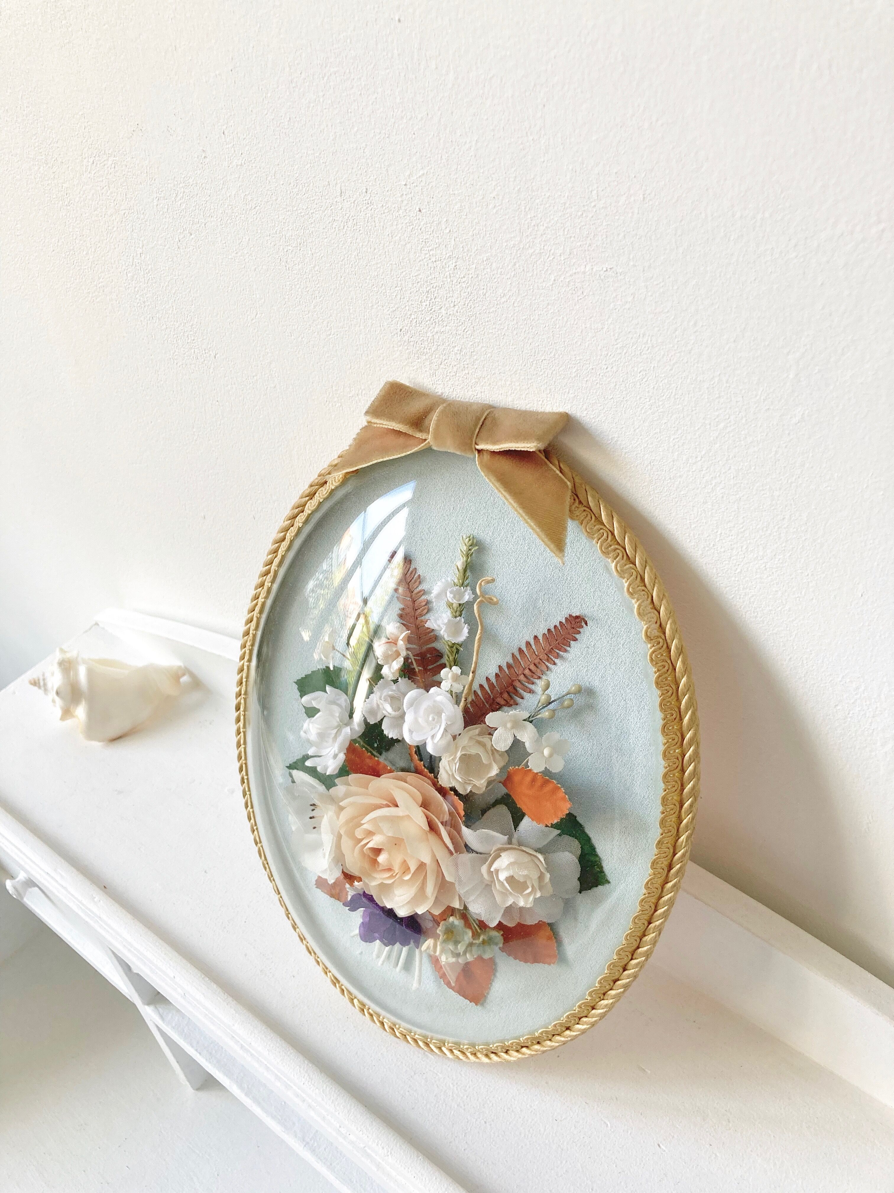 Frame domed glass flowers in fabric