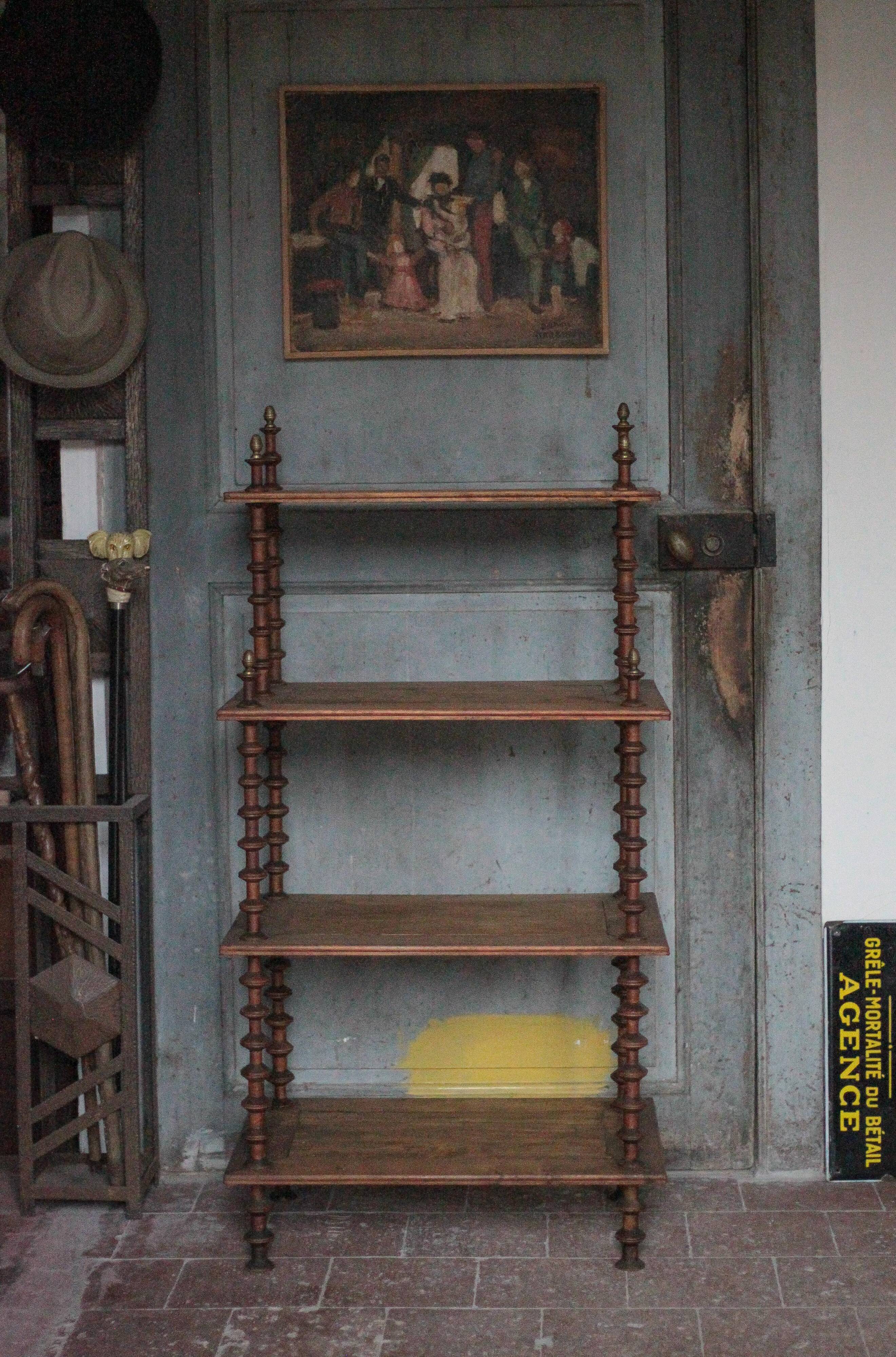 Napoleon III spool shelf, floor-standing shelf with brass tips.