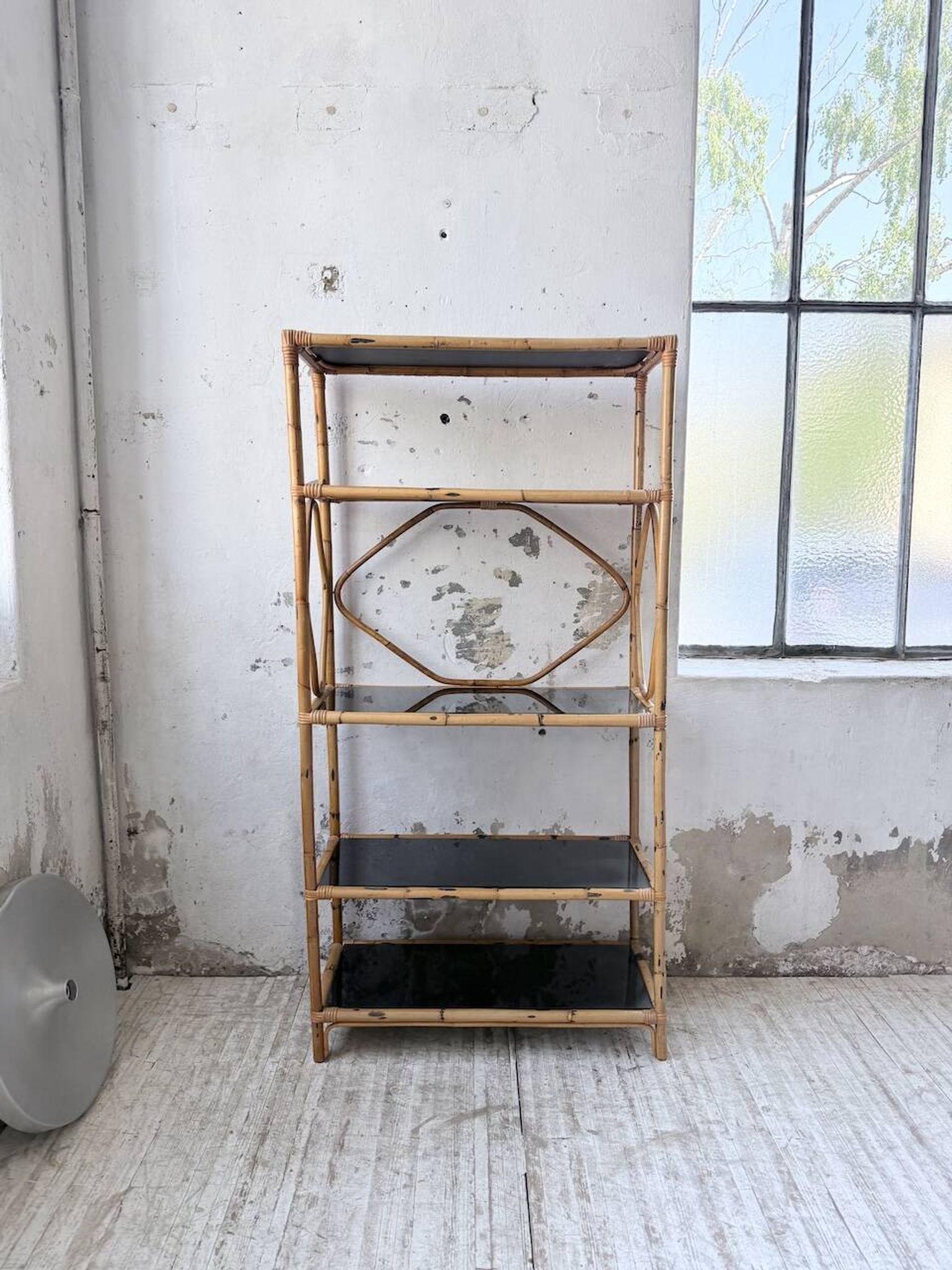 Rattan bookshelf and black glasses
