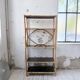 Rattan bookshelf and black glasses
