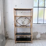 Rattan bookshelf and black glasses