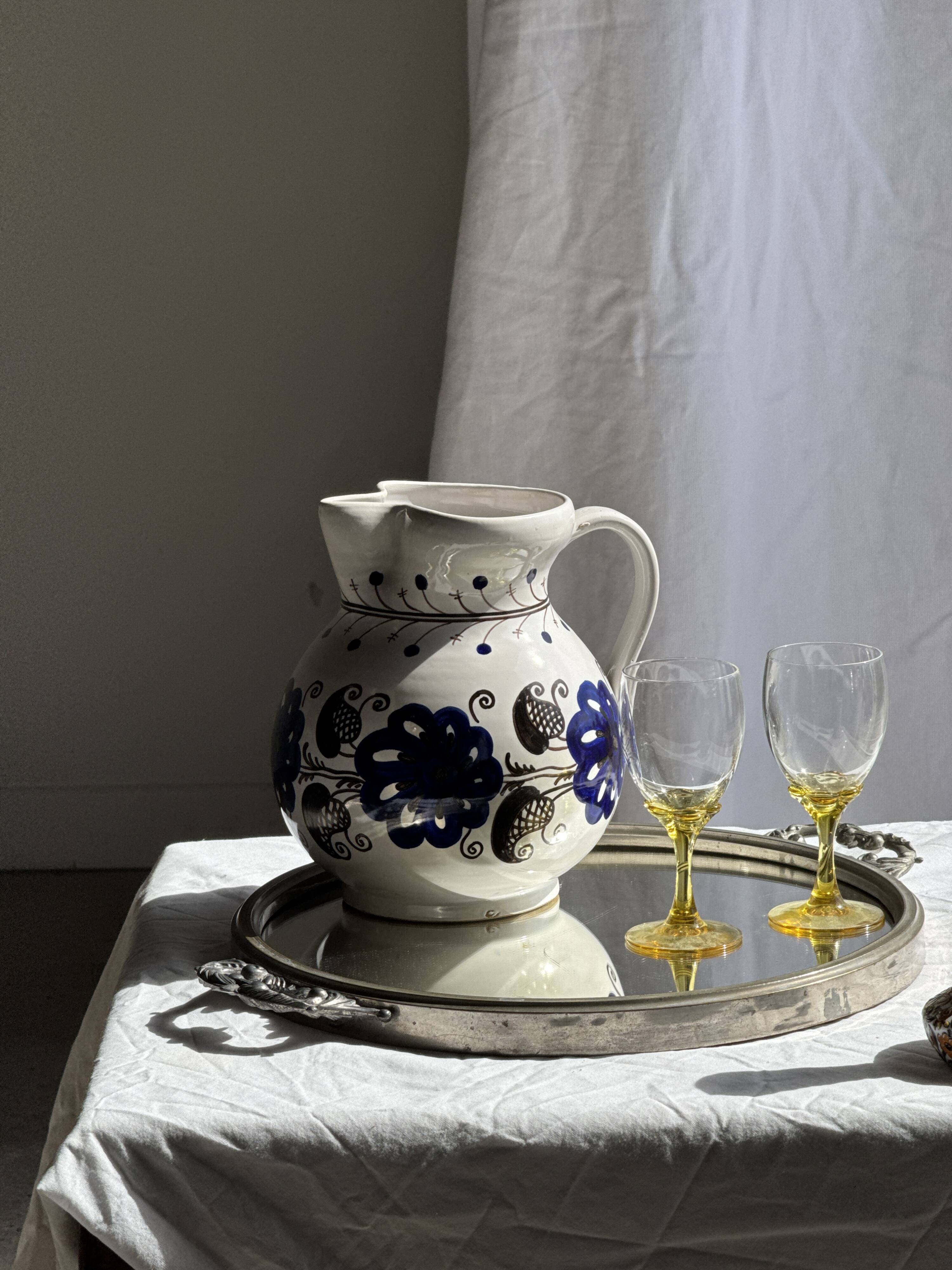 Very large vintage ceramic carafe in white glazed with blue floral decoration.