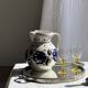 Very large vintage ceramic carafe in white glazed with blue floral decoration.