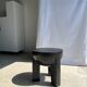 Black mango wood tripod side table with a semi-spherical top, height: 45 cm, diameter: 44 cm.