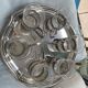 6 small glasses in their silver metal holder, with handle
