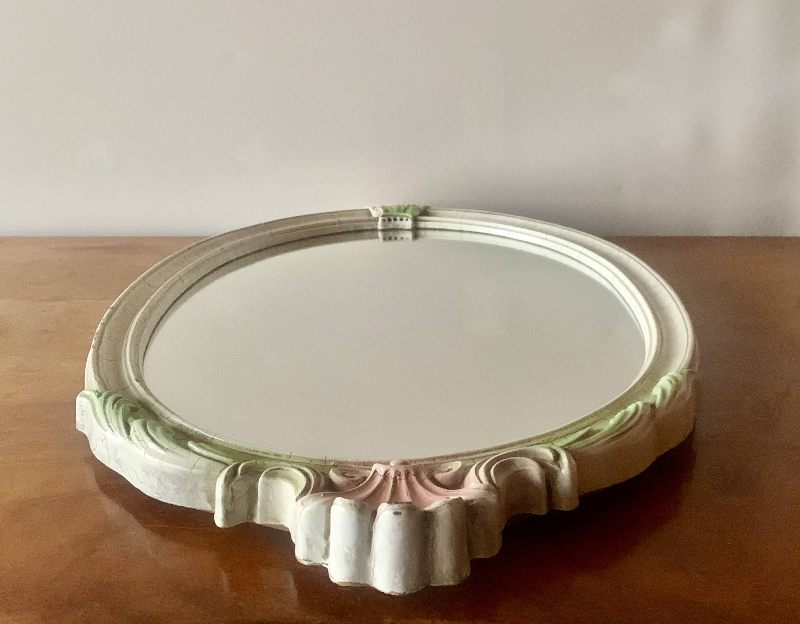 Vintage oval mirror in carved wood in pastel tones