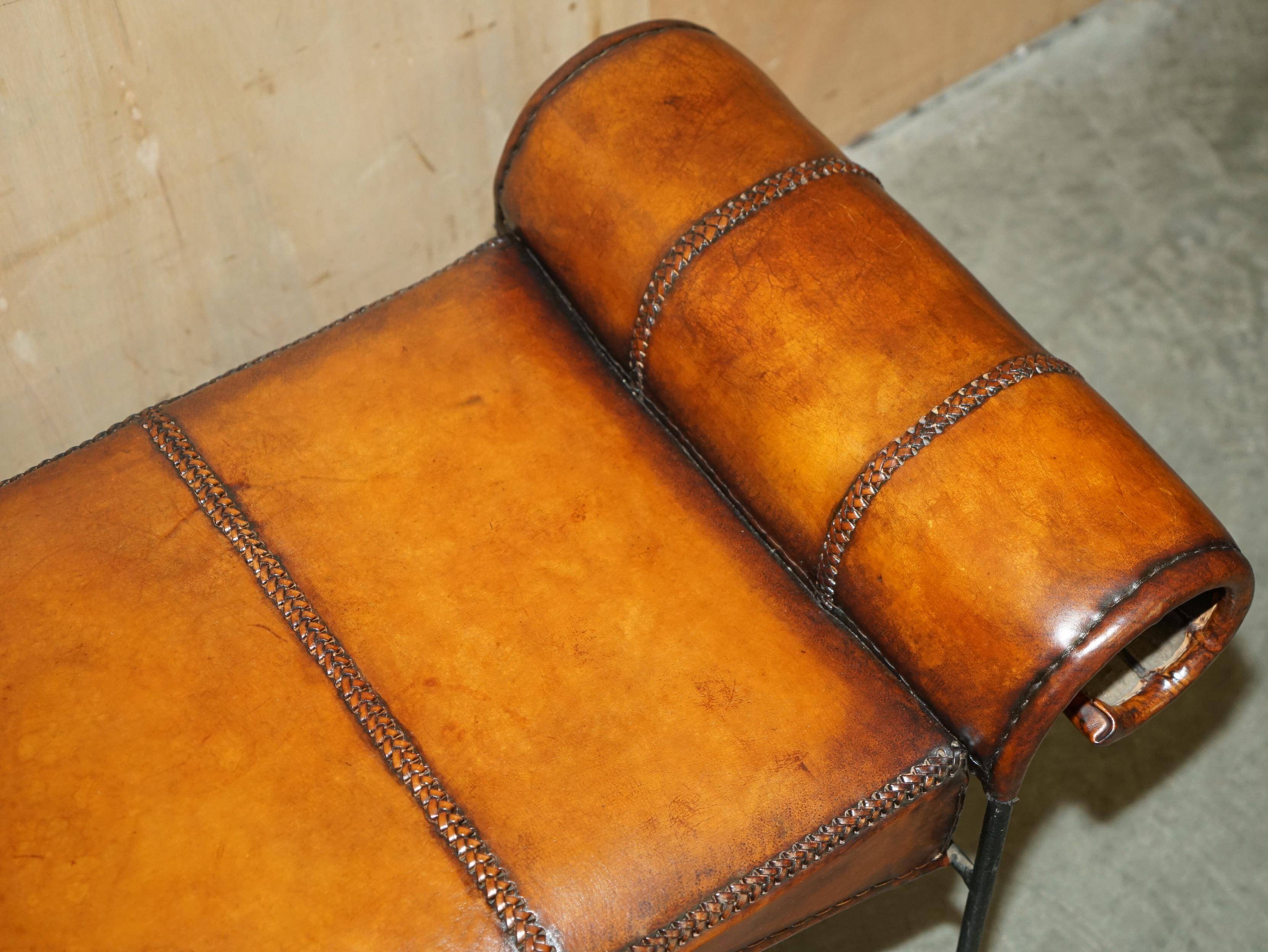 Vintage Spanish window bench in hand-stitched leather and restored iron.