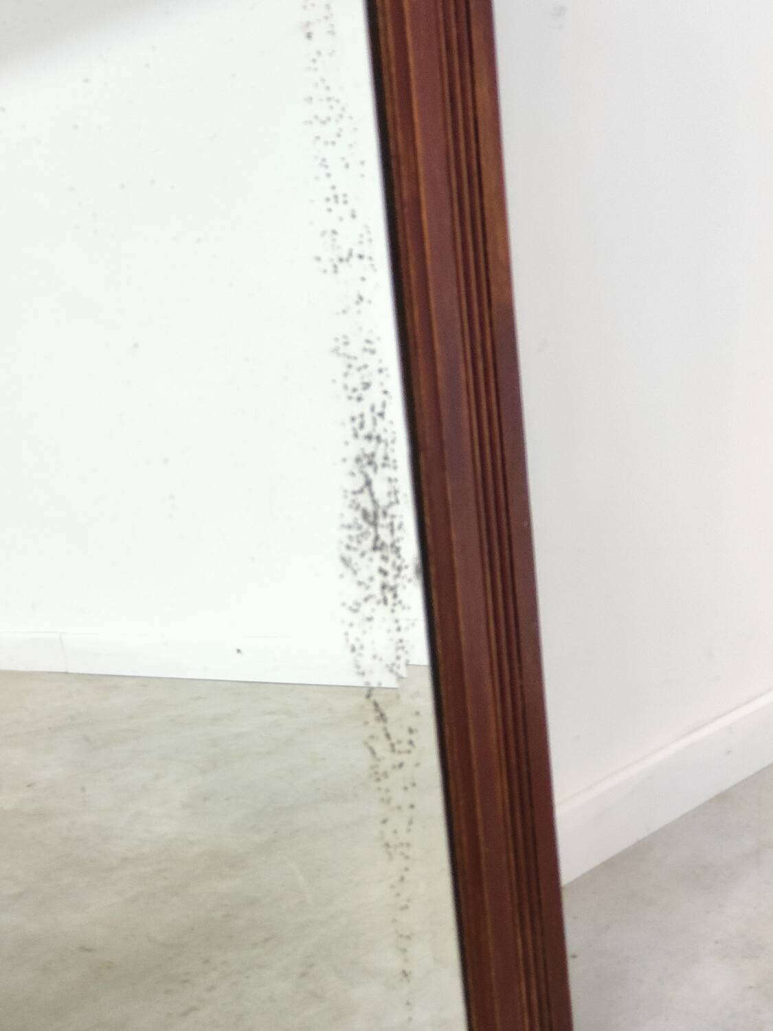 Antique beveled mirror on a wooden frame, 1930