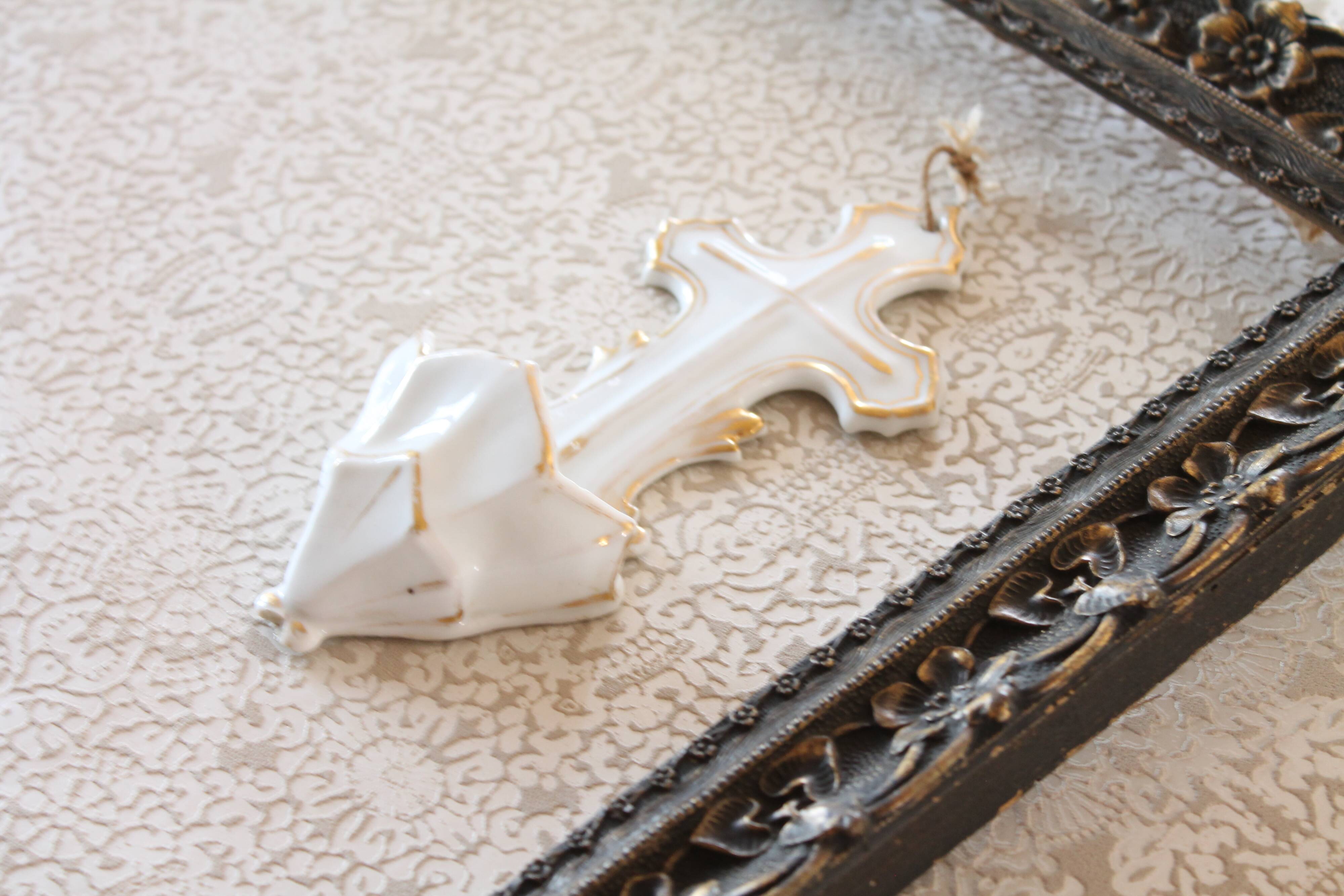 Antique holy water font in white porcelain biscuit.