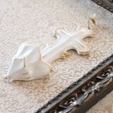 Antique holy water font in white porcelain biscuit.