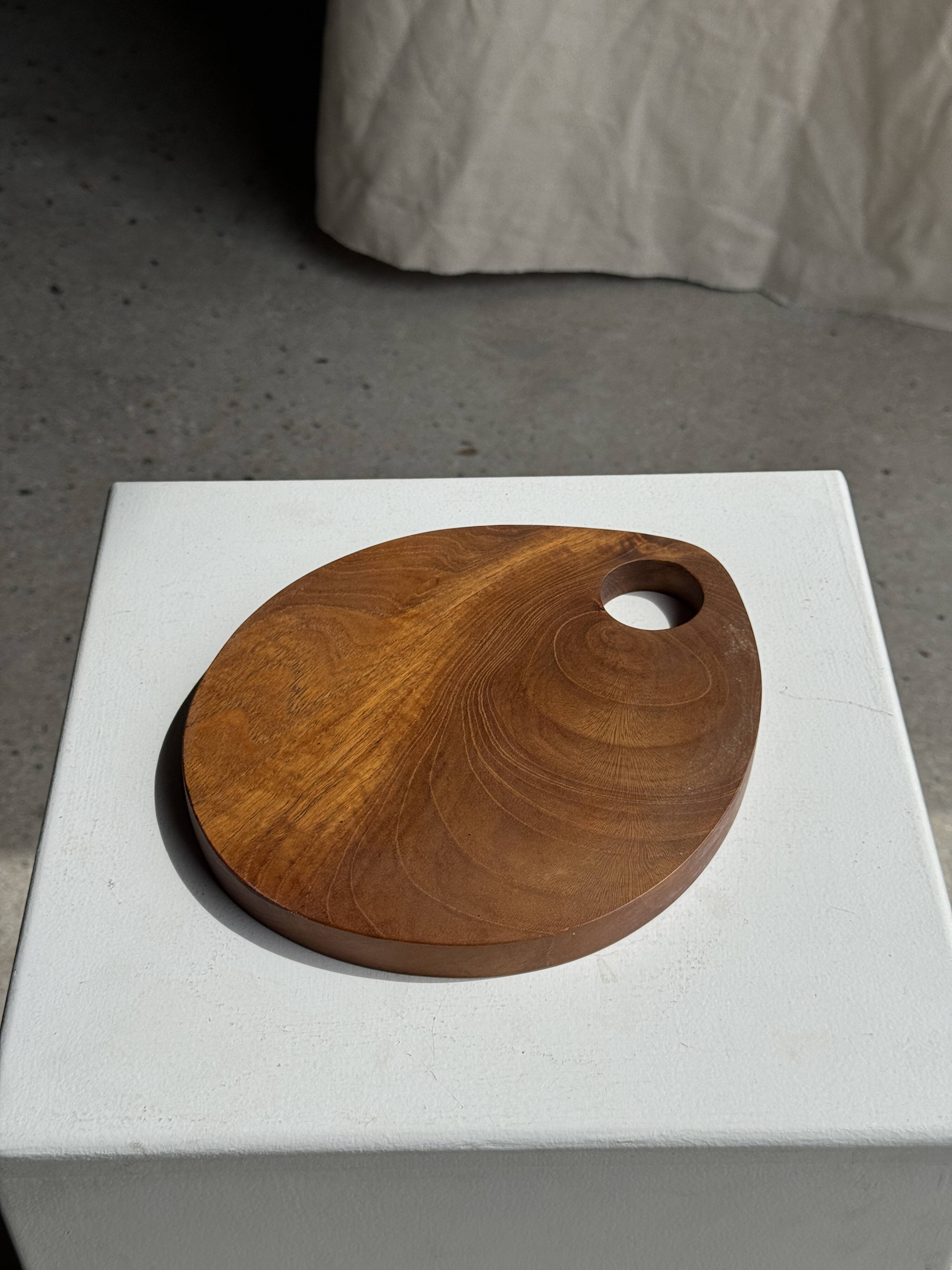 Small circular teak monoxyle cutting board with handle 22 x 13.