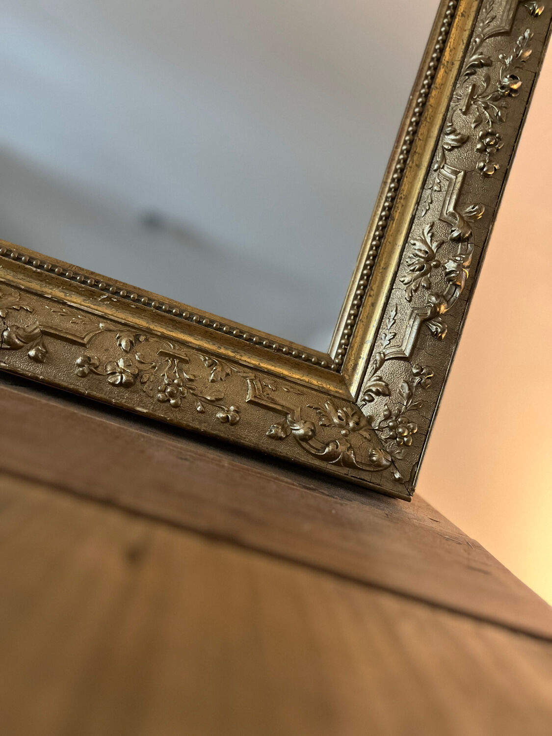 Gilded mirror with antique wood and stucco frame