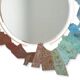 Contemporary mirror in oxidized bronze and brass with a deconstructed shape.