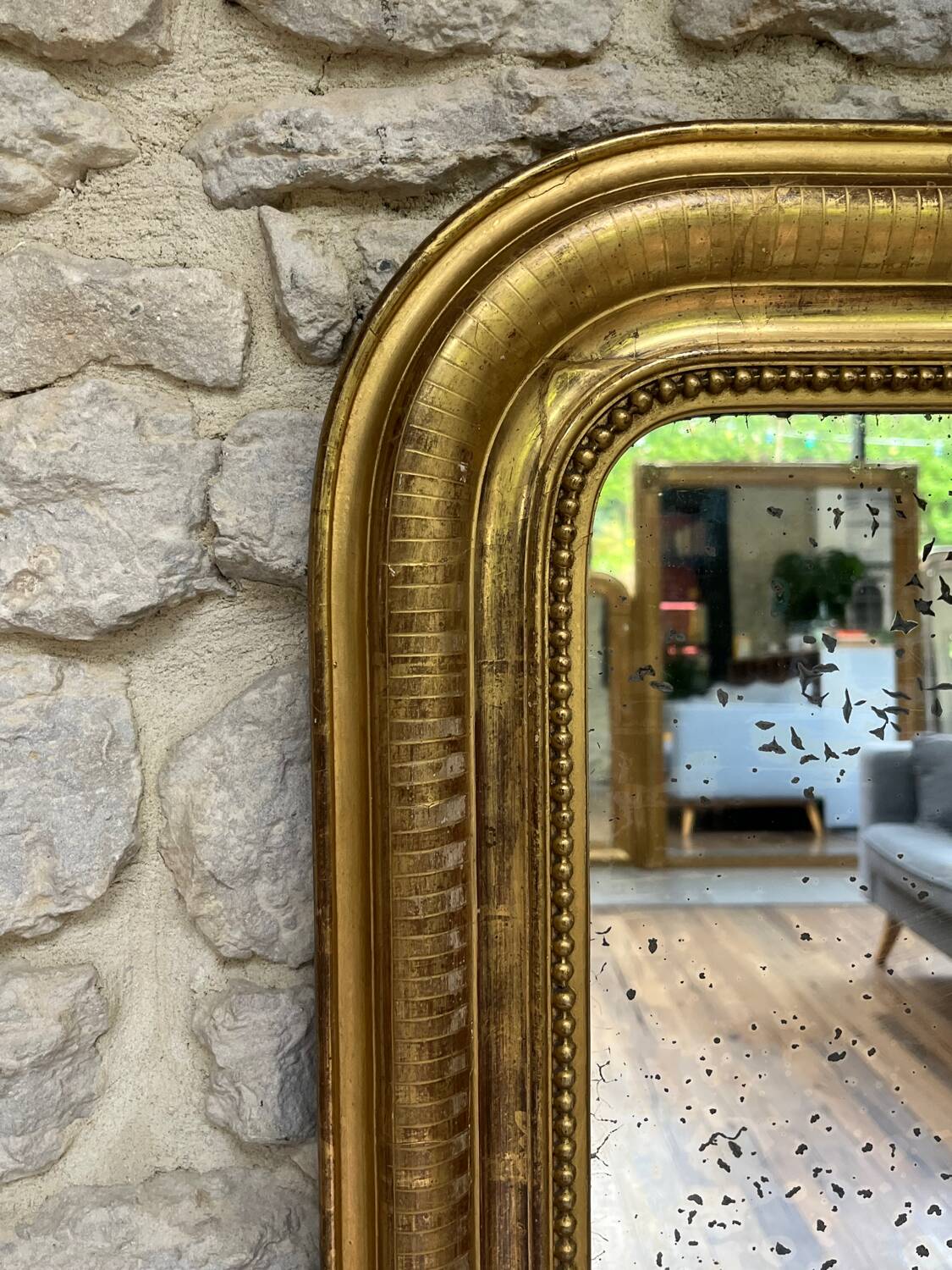 Louis-Philippe mantel mirror 133cm/115.5cm beaded gilded with gold leaf geometric decoration, late 19th century, heavily pitted and scratched glass, parquet on the back.