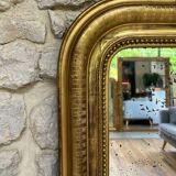 Louis-Philippe mantel mirror 133cm/115.5cm beaded gilded with gold leaf geometric decoration, late 19th century, heavily pitted and scratched glass, parquet on the back.