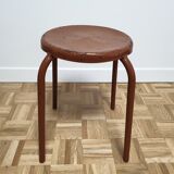 Rust-colored painted metal stool