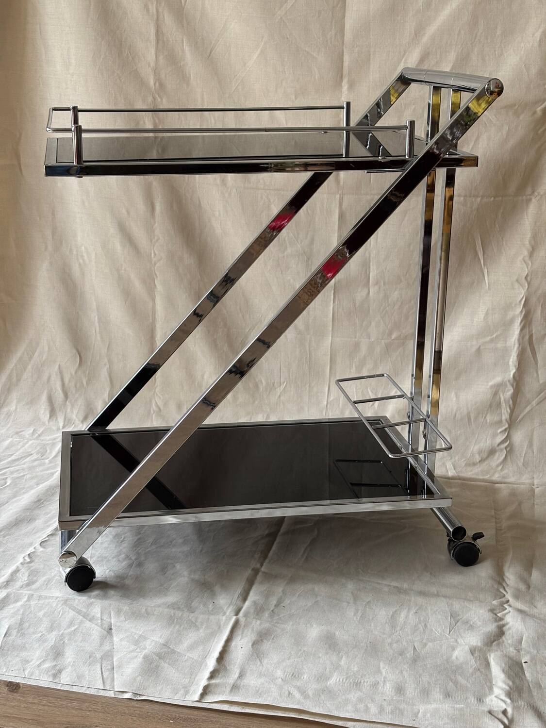 Modernist serving trolley in chromed metal and black smoked glass