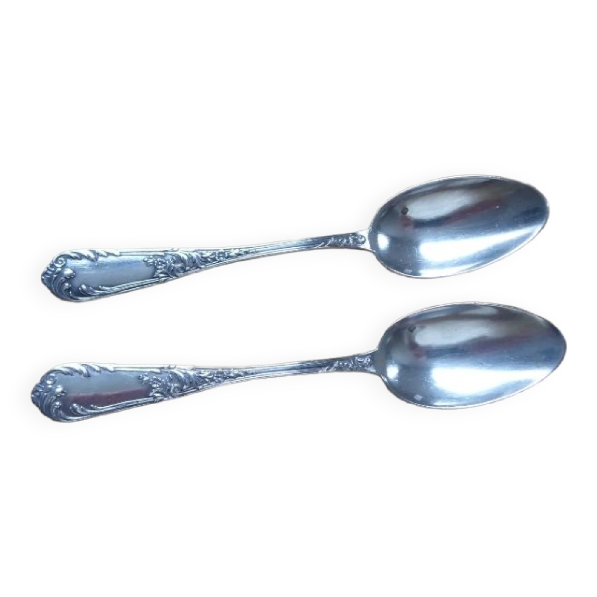 2 small white metal spoons