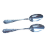 2 small white metal spoons